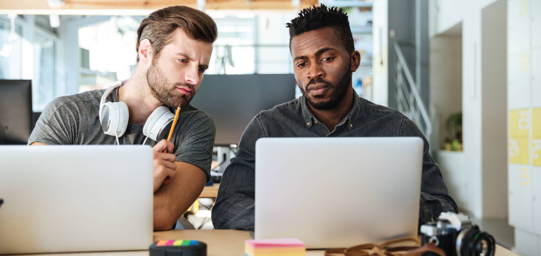 image of two men looking at laptops